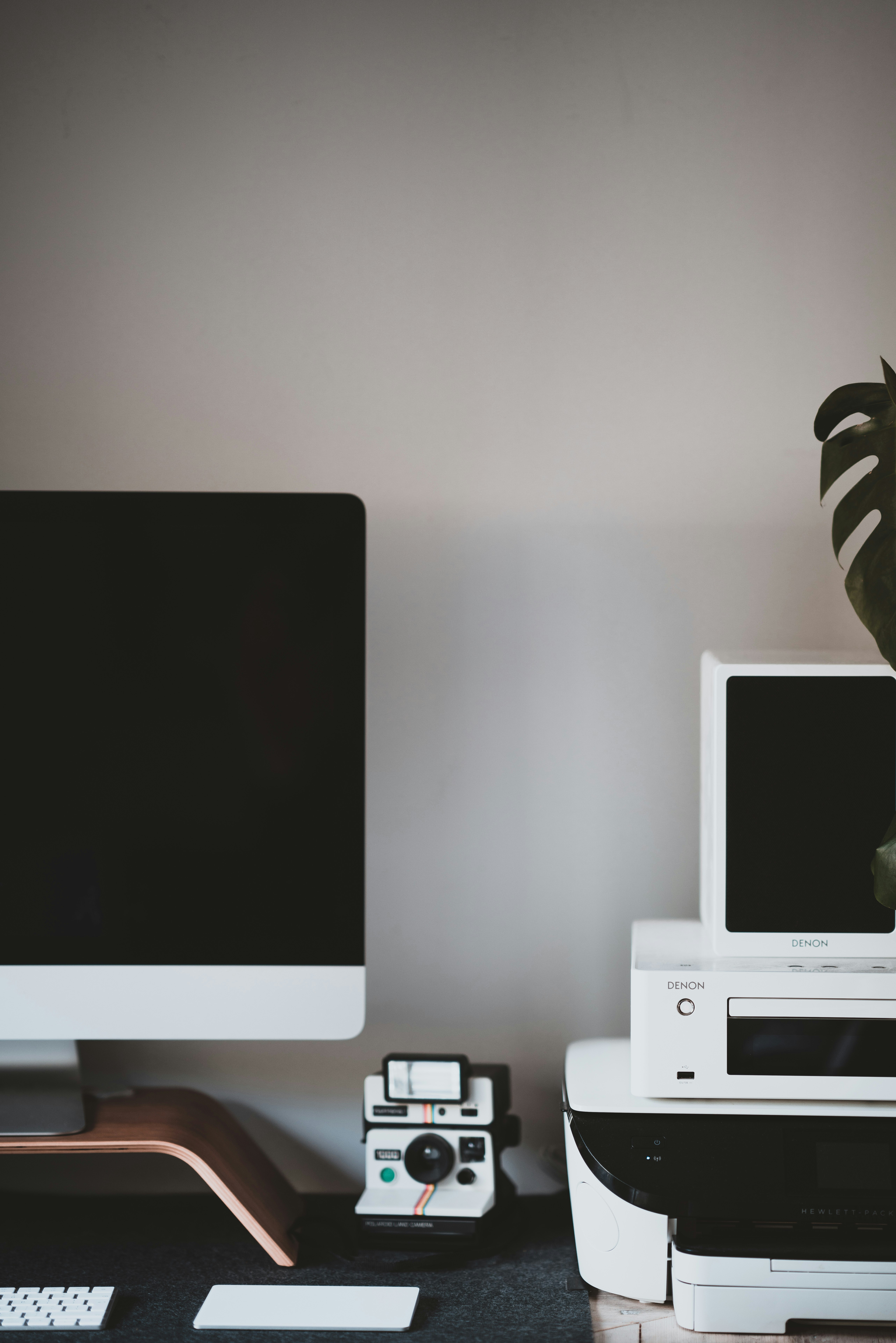 turned-off white monitor beside white camera